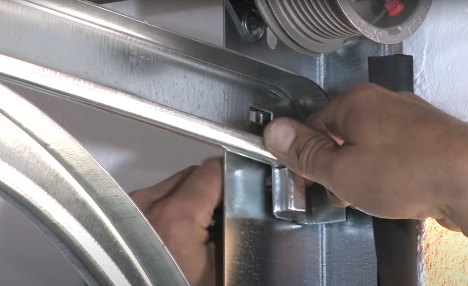 Professional performing garage door track repair in Grove City, Ohio, with tools and materials visible during precise repair work.