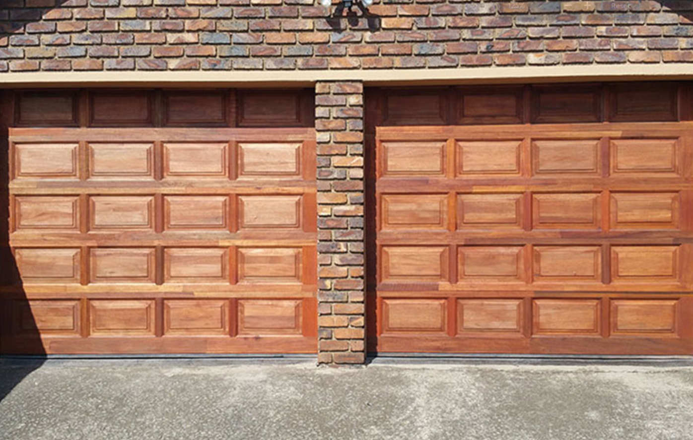 a technician repairing a residential garage door in Grove City, Ohio, showcasing professional garage door repair services.