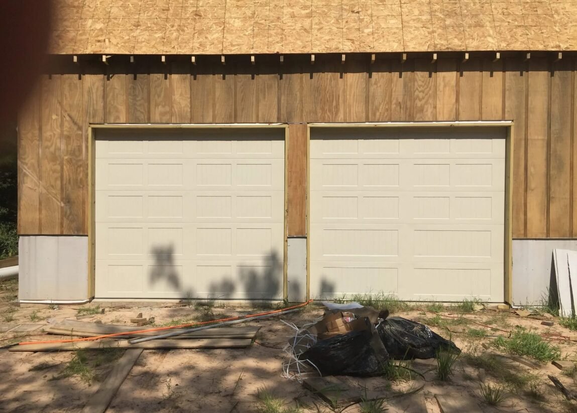 a technician repairing a residential garage door in Grove City, Ohio, highlighting the professional garage door repair services offered by Garage Door Repair Grove City Ohio LLC.