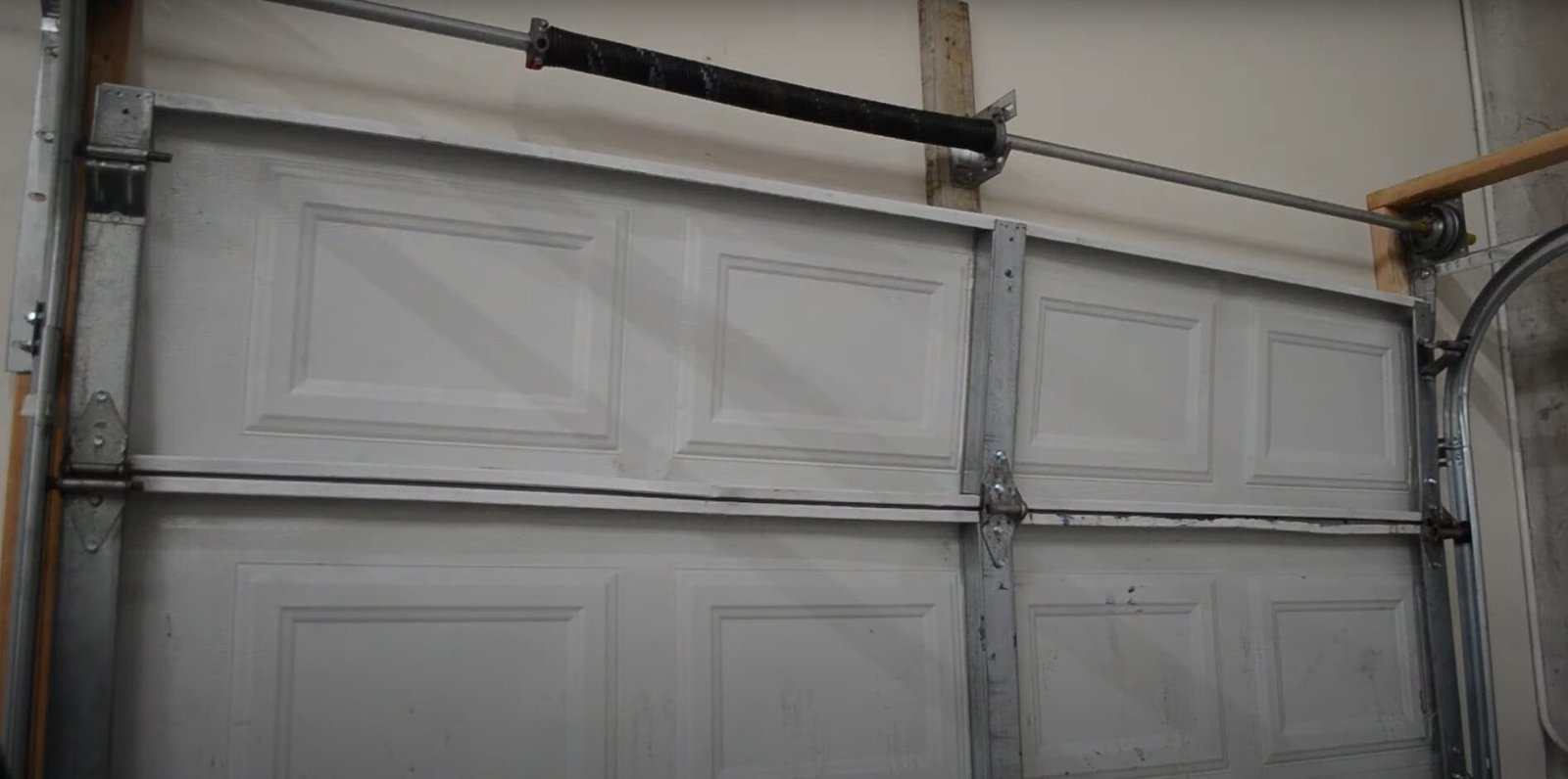 Iprofessional technician performing garage door spring repair in Grove City, Ohio. The technician is using specialized tools to ensure the garage door operates smoothly and safely.