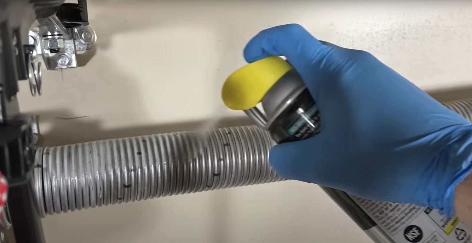 Close-up of a technician repairing a garage door spring in Grove City, Ohio - Expert garage door spring repair service.