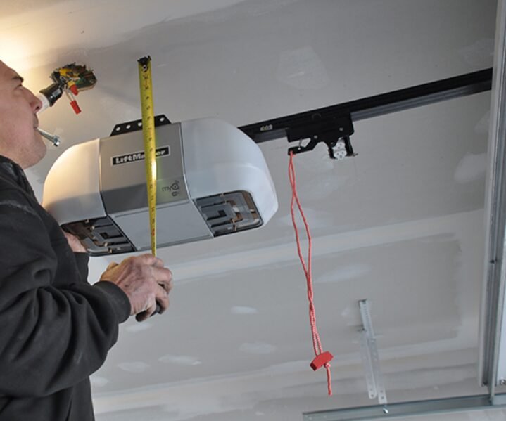 Technician performing garage door opener repair in Grove City, Ohio