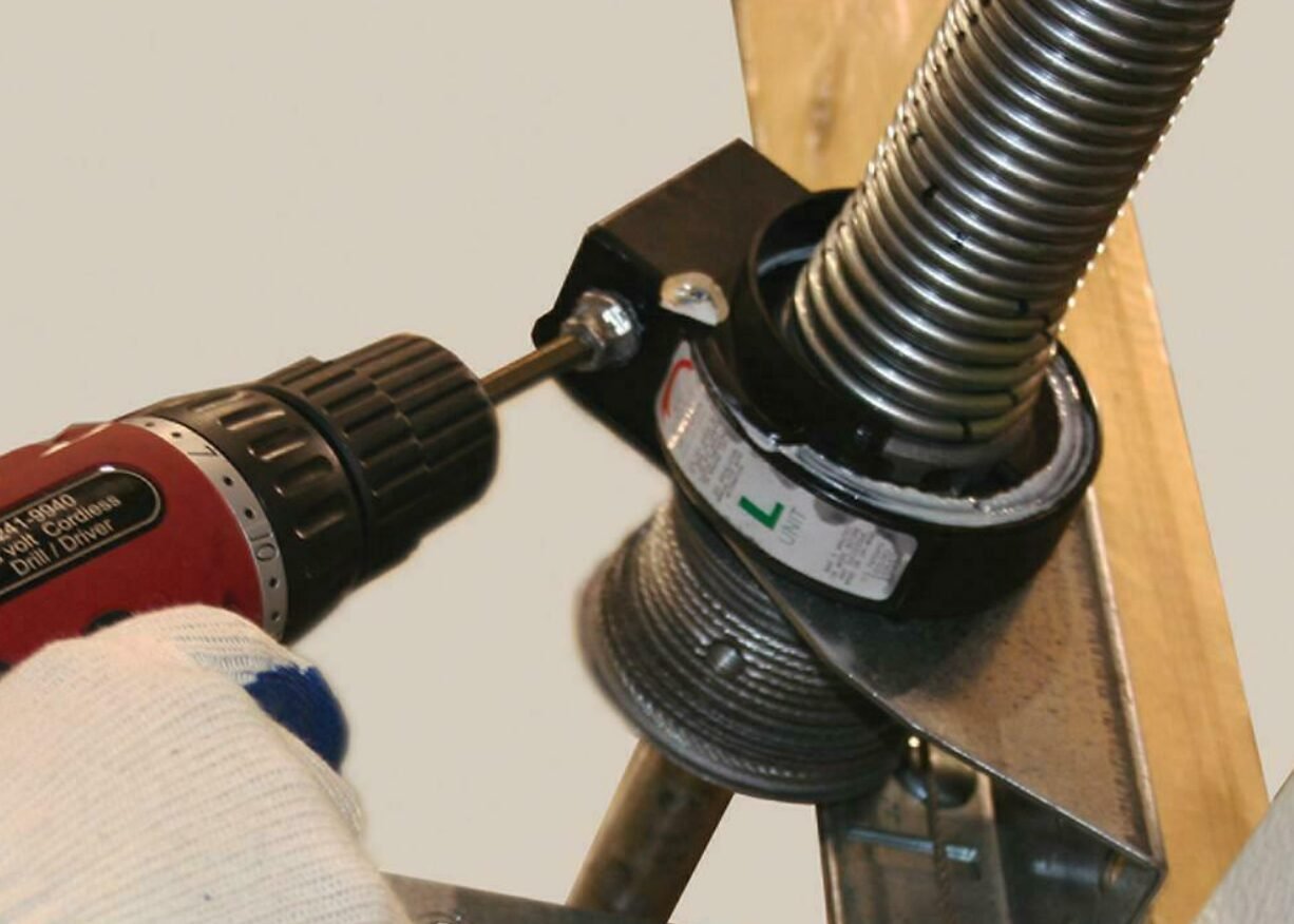 a professional technician performing garage door spring repair in Grove City, Ohio, ensuring a smoothly functioning garage door.